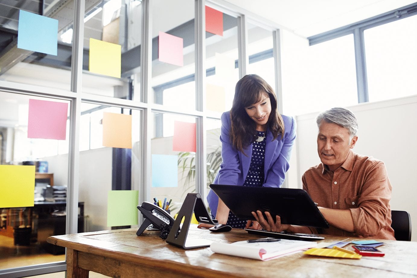 stock photo of woman working with a man at a desk